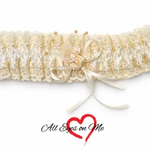 Off-white lace garter with satin rose, ribbon loops, pearl accents and gold-trimmed band