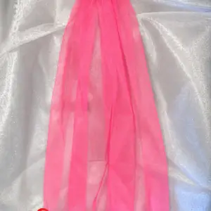 Hot pink tulle veil finished with Dark pink feather trim.