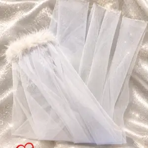 Off-white veil with white feather trim and sparkly tinsel