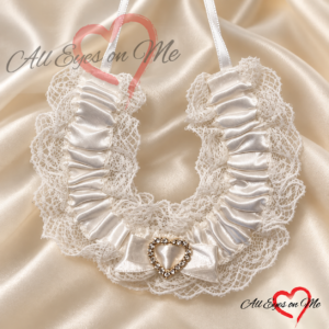 White satin bridal horseshoe with a central rhinestone-look heart detail, lace edging, satin bow and hanging loop