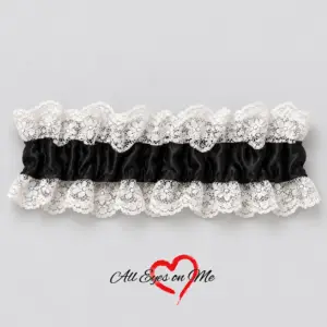 One black wrist garter with a gathered band and white floral lace trim