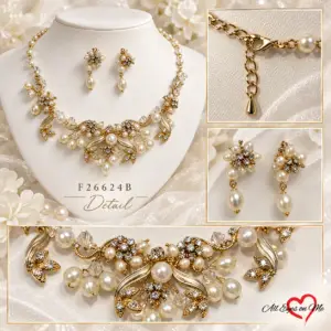 Gold-tone bridal necklace and matching drop earrings with cream pearl-style beads, clear rhinestones and floral details.