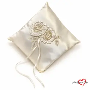 Off-white satin ring cushion with two beaded floral appliqués and ribbon ties