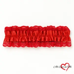 One red wrist garter with a gathered satin-look band and red lace trim